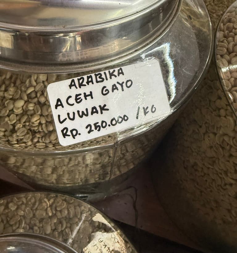 Green coffee beans in a market jar