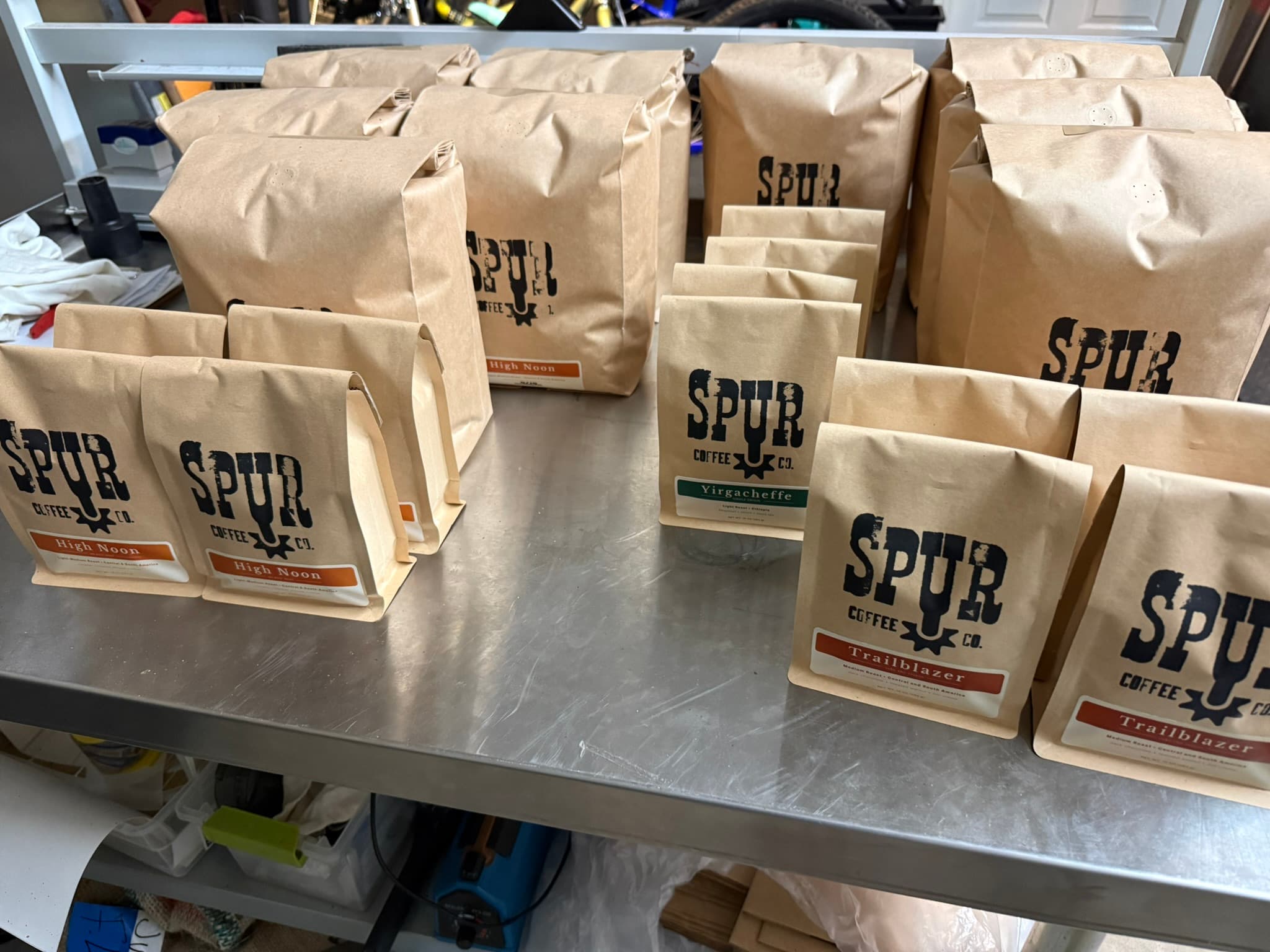 Spur Coffee bags on the stainless counter, ready for delivery